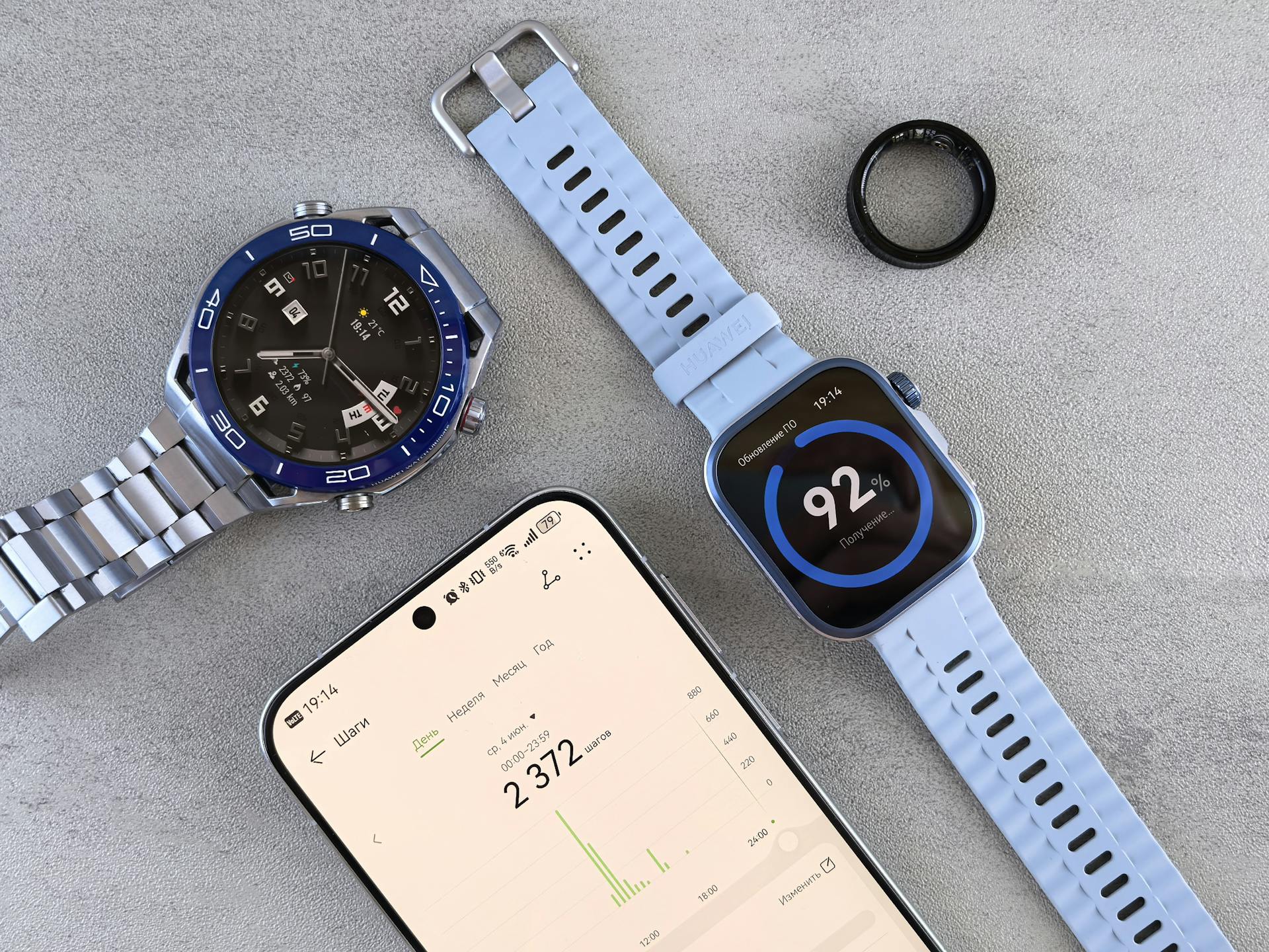 A smart ring resting on a nightstand next to a phone showing sleep data
